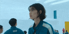 a woman in a blue jacket with the number 060 on the back