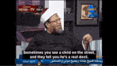 a man with a beard and glasses is talking on a television show