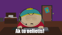 a south park character is sitting at a desk with a keyboard and the words ak tu nelietis written below him