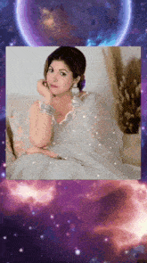 a woman in a white saree is sitting on a couch with a purple background