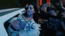 a woman in a crop top is dancing in front of a crowd wearing a shirt that says episode