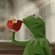 kermit the frog is drinking from a cup of tea