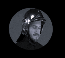 a man with a beard is wearing a helmet
