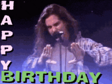 a man singing into a microphone with the words happy birthday written in green