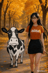a girl walking with a cow wearing a shirt that says ail6z