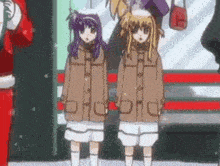 a couple of anime girls are standing next to each other in front of a santa claus .