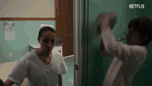 a nurse is standing next to another nurse in a room with a netflix logo on the bottom