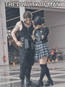a man and a woman are standing next to each other with the caption " the duality of man " above them