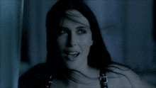 a woman with long black hair and a buckle around her neck