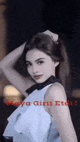 a woman in a white top with the words maya giriş etdi written on the bottom