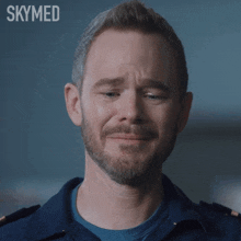 a close up of a man 's face with skymed written above him