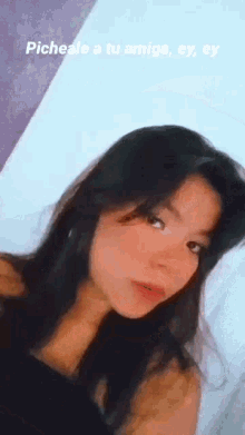 a close up of a woman 's face with a caption that says pichale a tu amiga