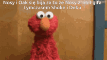 elmo from sesame street is standing in front of a wooden wall