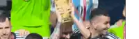 a group of soccer players holding a trophy in their hands .