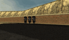 three elephants are walking down a road in front of a wall