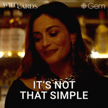 a woman says " it 's not that simple " in a dark room