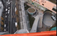 an aerial view of a city with a ferris wheel in the background