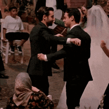 a bride and groom are dancing at a wedding reception