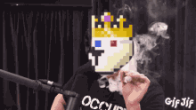 a man wearing an occupy shirt is smoking a cigarette in front of a microphone