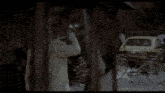 a man in a straw hat is walking down a street
