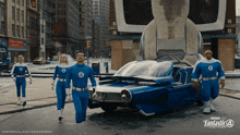 a group of people in fantastic 4 costumes are walking down a street