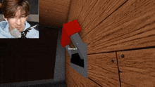 a man is playing a video game with a red button that says interact