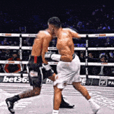 two boxers are fighting in a ring with a bet36 banner