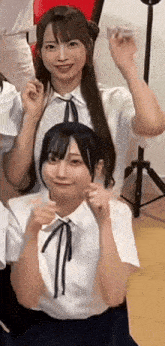 a group of young girls are posing for a picture and one of them is smiling .