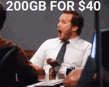 a man in a white shirt and tie is sitting at a table with his mouth open and the words 200gb for $ 40 written above him