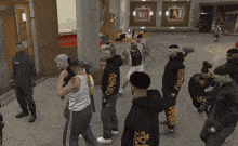 a group of men are standing in a room with one wearing a black hoodie with a leopard print