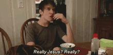 a man is sitting at a table with a bowl of cereal and says really jesus really ?