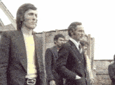 a group of men are standing in a line and one of them has a belt with the number 8 on it