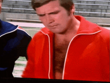 a man in a red jacket with a white stripe on the sleeves