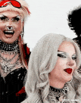 a group of drag queens are posing for a photo and one of them has a nose ring