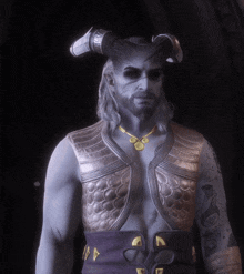a man with horns and a beard wears a gold necklace