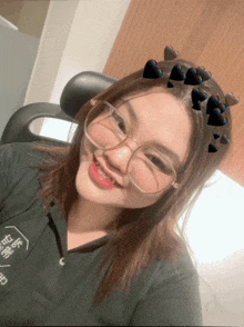 a girl wearing glasses and braces smiles for the camera with hearts around her head