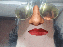 a close up of a woman 's face with a nose and red lips