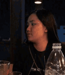 a woman wearing a black shirt that says fh on the front