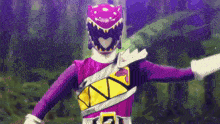 a purple ranger with a black helmet and a yellow belt