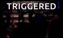 a man is dancing on a stage in front of a crowd with the word triggered above him