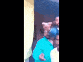 a blurry picture of a man in a blue shirt pointing at something