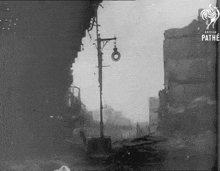 a black and white photo of a destroyed city street with the words pathe at the bottom