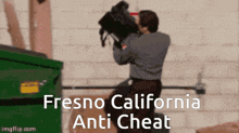 a man holding a camera in front of a dumpster with the words fresno california anti cheat on the bottom