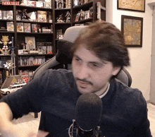 a man sitting in front of a microphone with the word think jules on the bottom left