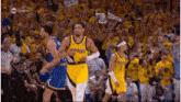 a basketball game is being played in front of a crowd of people .
