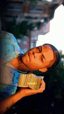 a person holding a stack of cards with svngrt written on the front