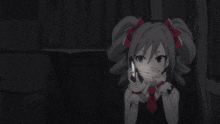 a girl with pigtails covering her mouth with her hands