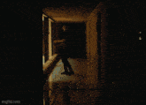a man is sitting on a bed in front of a fan with the url imgflip.com at the bottom