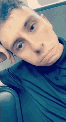 a man in a black shirt is taking a picture of himself