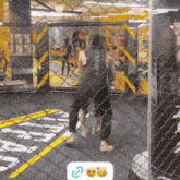 a man in a black le mills shirt is standing in a cage